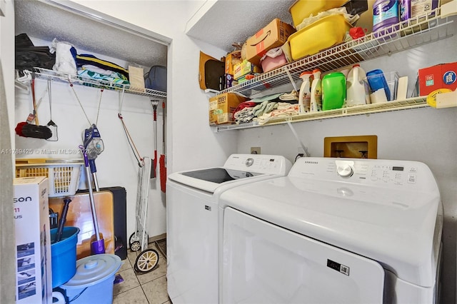 washroom with laundry area, light tile patterned floors, and washing machine and dryer