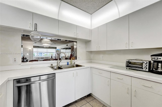 kitchen with light tile patterned flooring, a sink, light countertops, a toaster, and stainless steel dishwasher