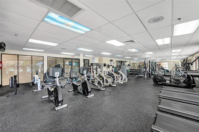 workout area with visible vents and a paneled ceiling