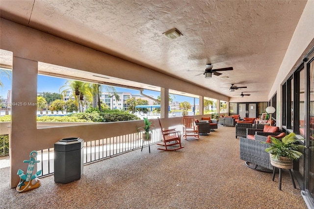 view of patio / terrace with ceiling fan and an outdoor living space