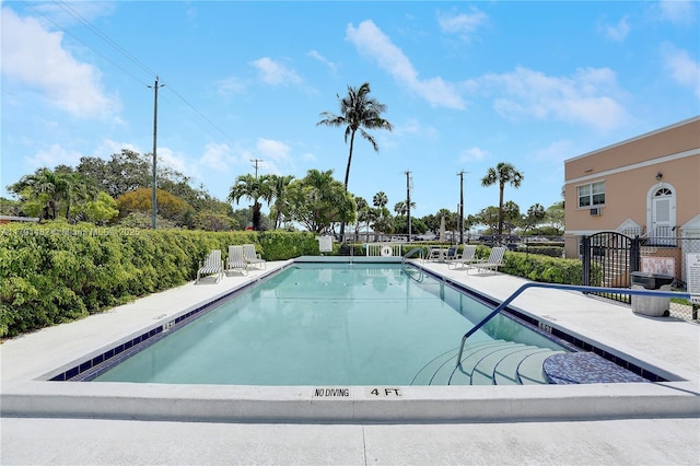 pool with fence and a patio
