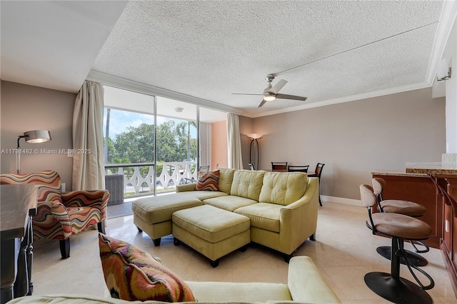 living room featuring a textured ceiling, ceiling fan, light tile patterned floors, and a wall of windows
