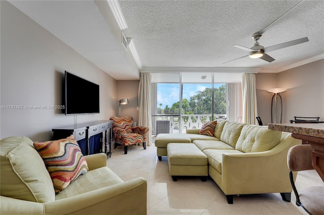 living room with visible vents, ornamental molding, a wall of windows, ceiling fan, and a textured ceiling