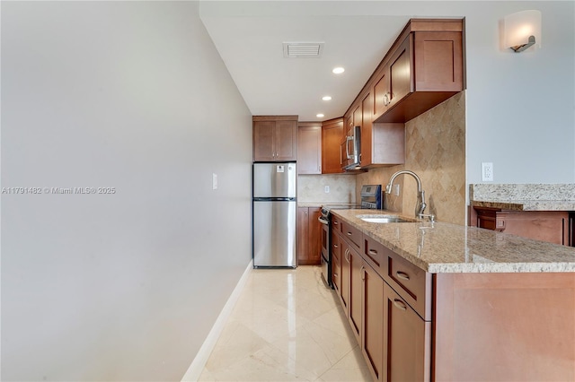 kitchen featuring backsplash, appliances with stainless steel finishes, a sink, baseboards, and marble finish floor