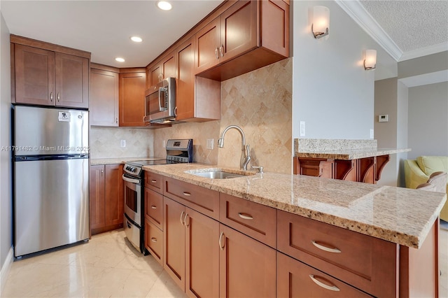 kitchen with backsplash, crown molding, appliances with stainless steel finishes, a sink, and light stone counters