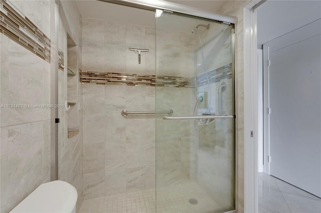 bathroom with toilet and a stall shower