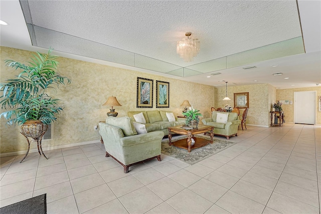 living room with baseboards, a textured ceiling, an inviting chandelier, and light tile patterned floors