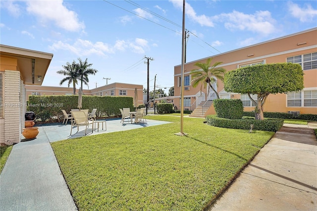 surrounding community with a lawn, a patio area, and fence