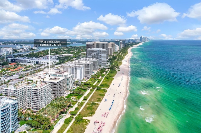 birds eye view of property with a water view and a view of the beach