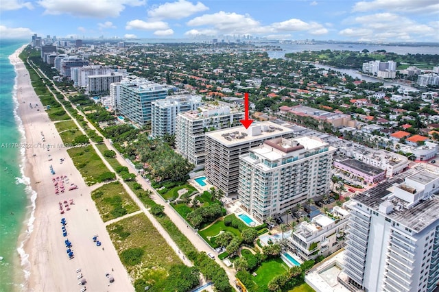 aerial view featuring a water view, a city view, and a view of the beach