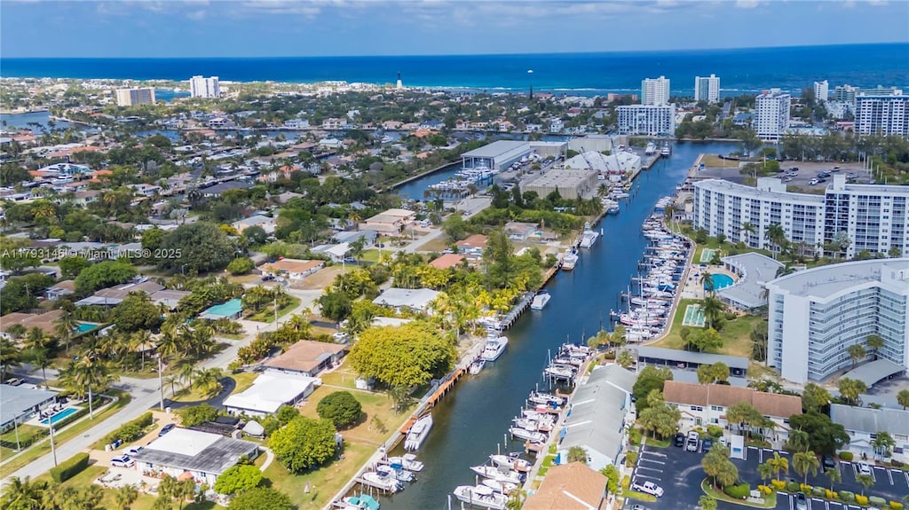 birds eye view of property with a water view and a city view