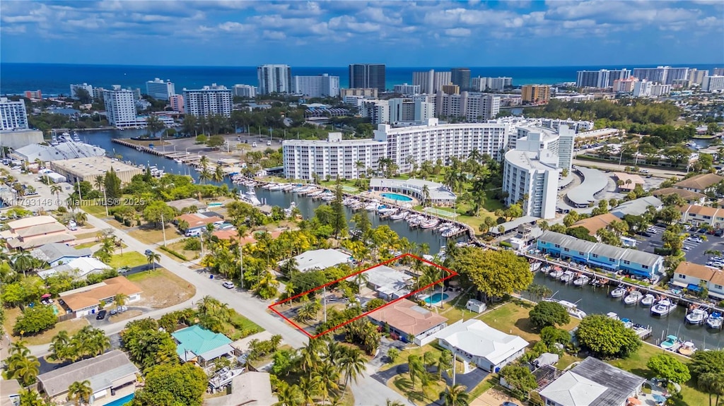 birds eye view of property featuring a city view and a water view