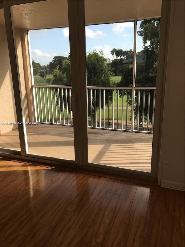 doorway to outside with a healthy amount of sunlight and wood finished floors