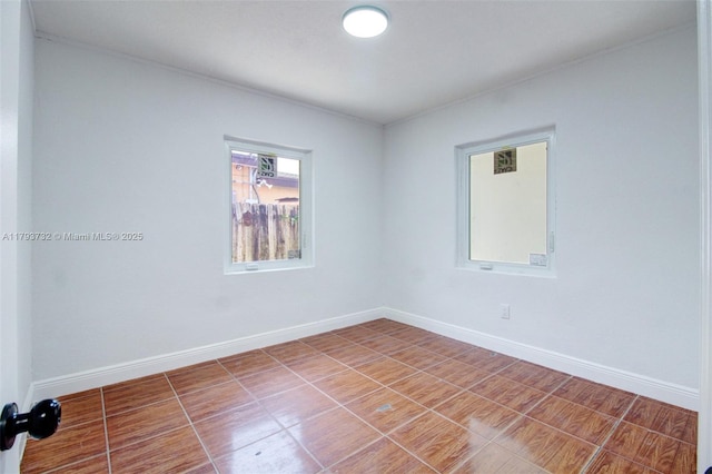 spare room featuring baseboards and ornamental molding