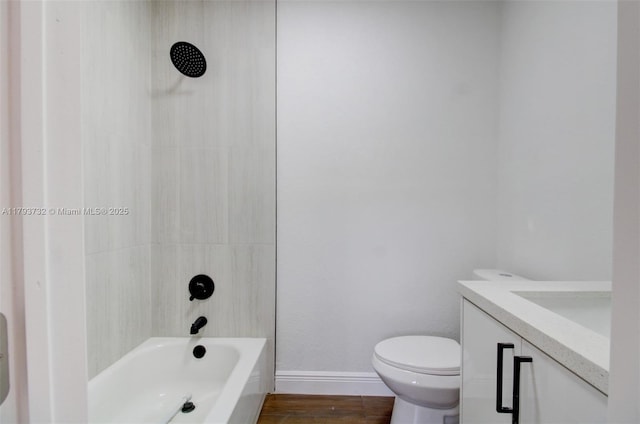 bathroom featuring vanity, shower / bathtub combination, wood finished floors, toilet, and baseboards