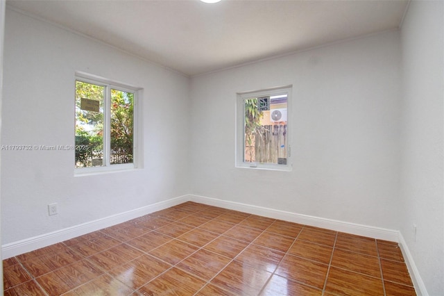 unfurnished room with baseboards