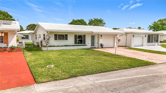 ranch-style house with stucco siding, an attached garage, driveway, and a front lawn