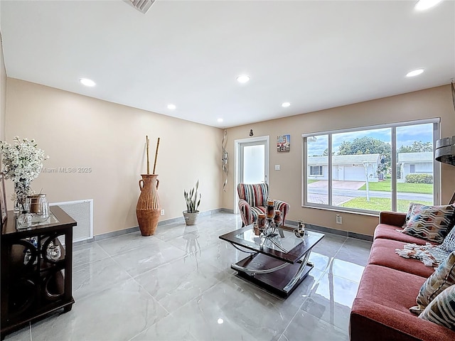 living area featuring baseboards, recessed lighting, and visible vents