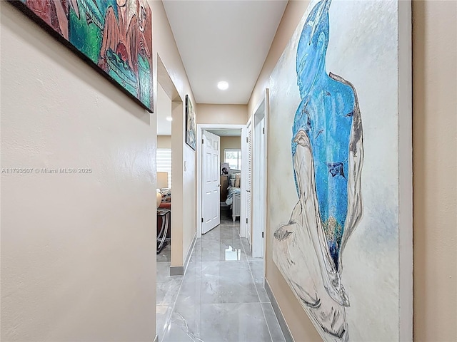 hall with recessed lighting, baseboards, and marble finish floor