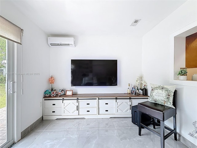 living area with baseboards, visible vents, a wall mounted AC, and marble finish floor
