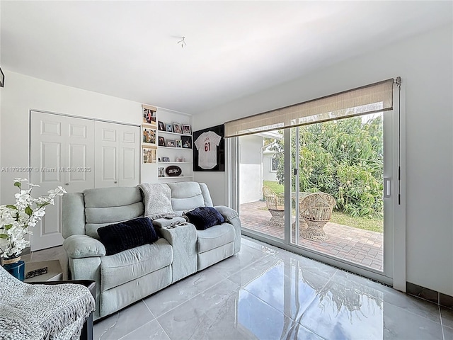 living area featuring marble finish floor
