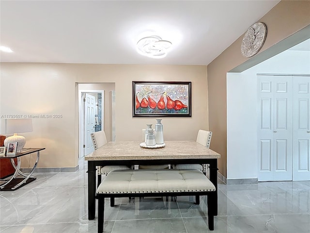 dining room featuring baseboards and marble finish floor