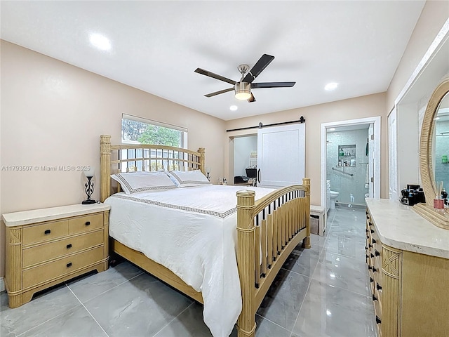 bedroom featuring a ceiling fan, ensuite bath, a barn door, marble finish floor, and recessed lighting