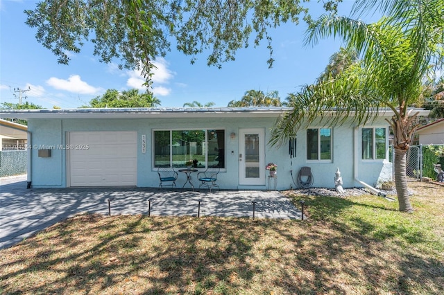 1531 NE 32nd St, Pompano Beach, FL 33064 - ranch-style house with a garage, stucco siding, and concrete driveway