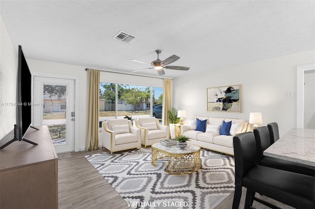 1531 NE 32nd St, Pompano Beach, FL 33064 - living room featuring a ceiling fan, light wood finished floors, and visible vents