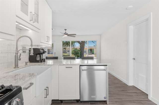 1531 NE 32nd St, Pompano Beach, FL 33064 - kitchen featuring decorative backsplash, a peninsula, white cabinets, and stainless steel appliances