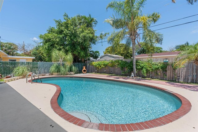 1531 NE 32nd St, Pompano Beach, FL 33064 - view of swimming pool with a fenced in pool, a fenced backyard, and a patio area
