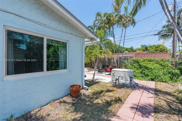 1531 NE 32nd St, Pompano Beach, FL 33064 - view of side of property featuring fence, a patio area, and stucco siding