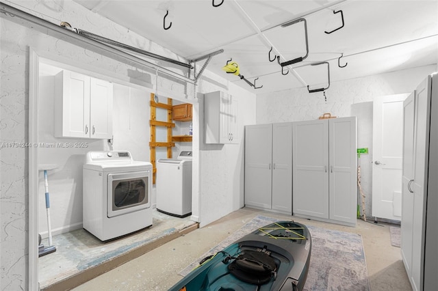 1531 NE 32nd St, Pompano Beach, FL 33064 - laundry area with a garage, cabinet space, and washing machine and clothes dryer