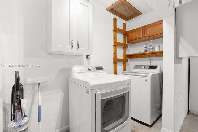 1531 NE 32nd St, Pompano Beach, FL 33064 - laundry room with baseboards, cabinet space, and washer and clothes dryer