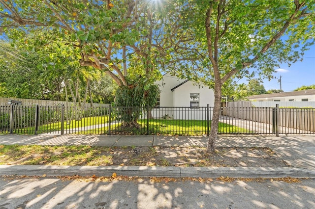 view of side of property with a lawn and a fenced front yard