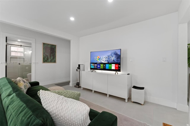 living area featuring baseboards and recessed lighting