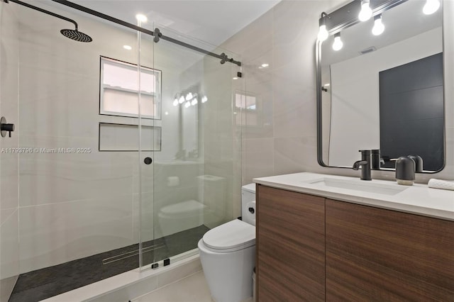 bathroom featuring vanity, a stall shower, toilet, and visible vents