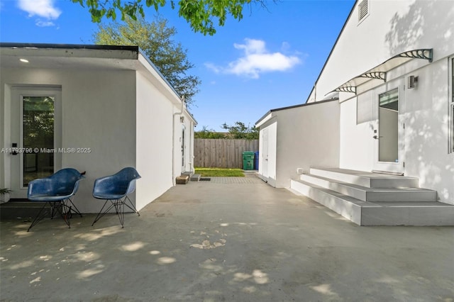 view of patio featuring fence and visible vents