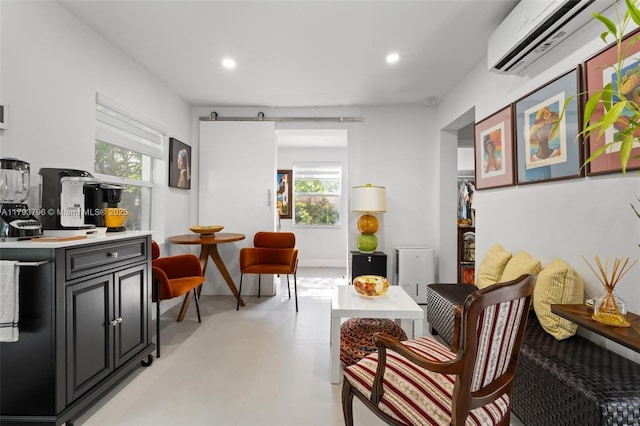 living area with recessed lighting and a wall mounted AC
