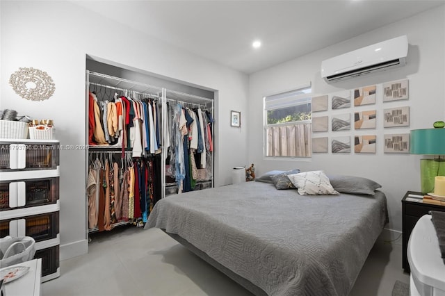 bedroom with finished concrete floors, a wall mounted air conditioner, recessed lighting, and a closet