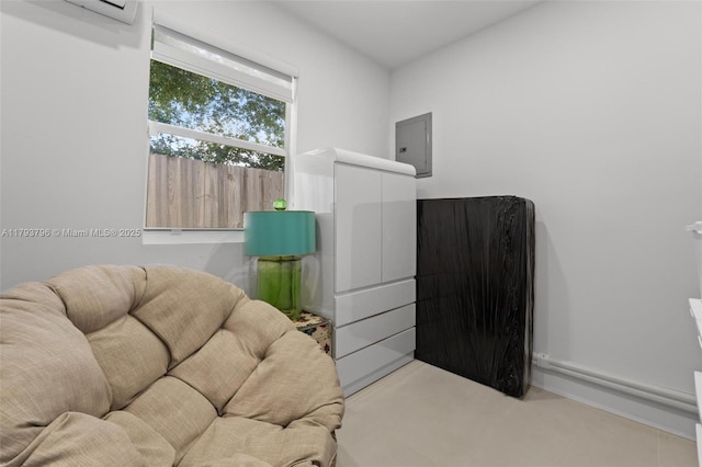 sitting room with an AC wall unit and electric panel