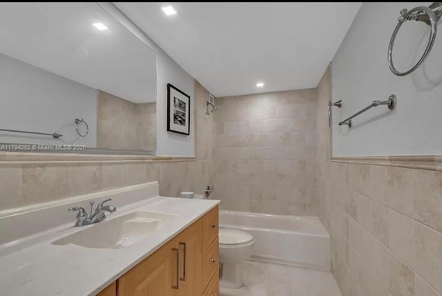 5401 Collins Ave Unit 411, Miami Beach, FL 33140 - full bathroom featuring vanity, bathing tub / shower combination, toilet, tile walls, and recessed lighting