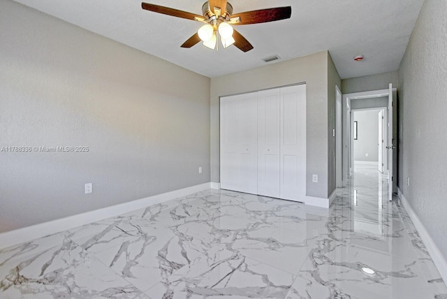 1062 SE 13th Ave, Homestead, FL 33035 - unfurnished bedroom with visible vents, a closet, marble finish floor, baseboards, and ceiling fan