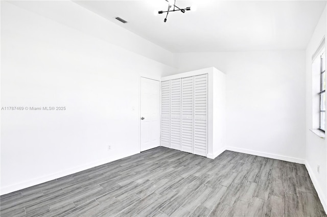 2917 NW Belmont Ln Unit 2917, Cooper City, FL 33026 - spare room with visible vents, baseboards, lofted ceiling, and wood finished floors