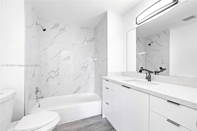 2917 NW Belmont Ln Unit 2917, Cooper City, FL 33026 - full bathroom featuring bathing tub / shower combination, vanity, toilet, and visible vents
