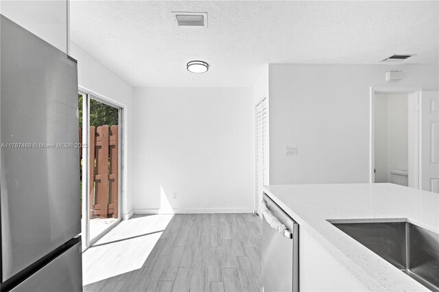 2917 NW Belmont Ln Unit 2917, Cooper City, FL 33026 - kitchen featuring stainless steel appliances, a textured ceiling, visible vents, and wood finish floors
