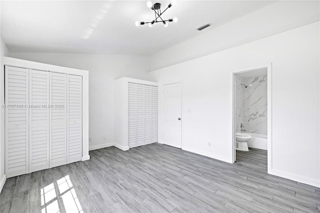 2917 NW Belmont Ln Unit 2917, Cooper City, FL 33026 - unfurnished bedroom featuring visible vents, wood finished floors, lofted ceiling, and an inviting chandelier