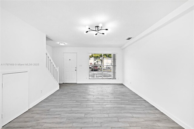 2917 NW Belmont Ln Unit 2917, Cooper City, FL 33026 - foyer entrance with baseboards, visible vents, light wood finished floors, and stairway
