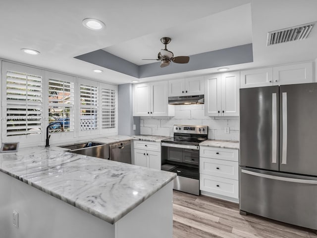 kitchen with stainless steel appliances, a ceiling fan, white cabinetry, under cabinet range hood, and visible vents