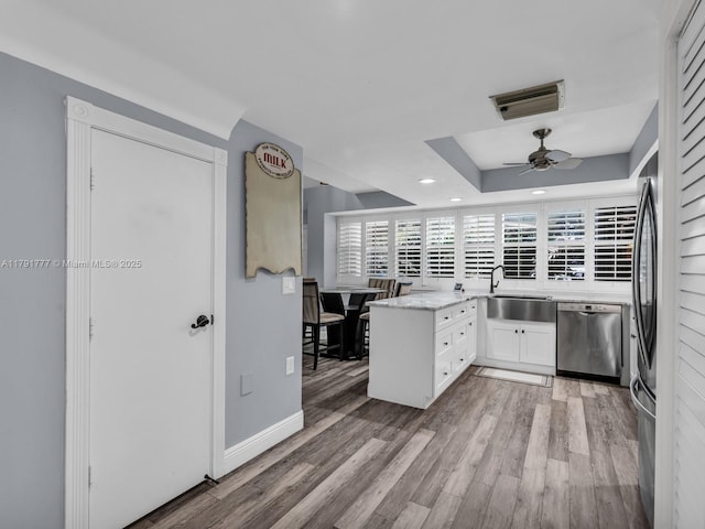 kitchen with stainless steel dishwasher, visible vents, recessed lighting, light wood-type flooring, and a sink